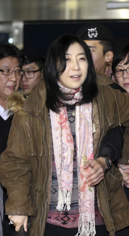 Shin Eun-mi, center, arrives at the Incheon International Airport for departure Saturday. Shin is involved in the latest in a series of cases that critics say infringe on the country’s freedom of speech because she complimented North Korea.
