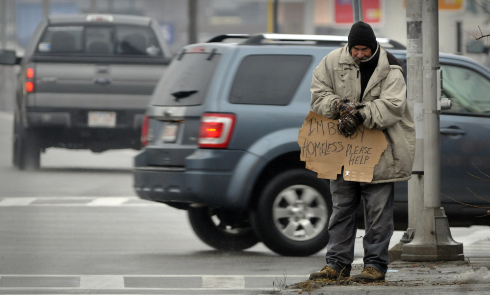 A panhandler asks for help at an intersection in Worcester, Mass., in 2013. The U.S. Supreme Court could decide to hear a challenge by the American Civil Liberties Union regarding a pair of 2013 panhandling ordinances.