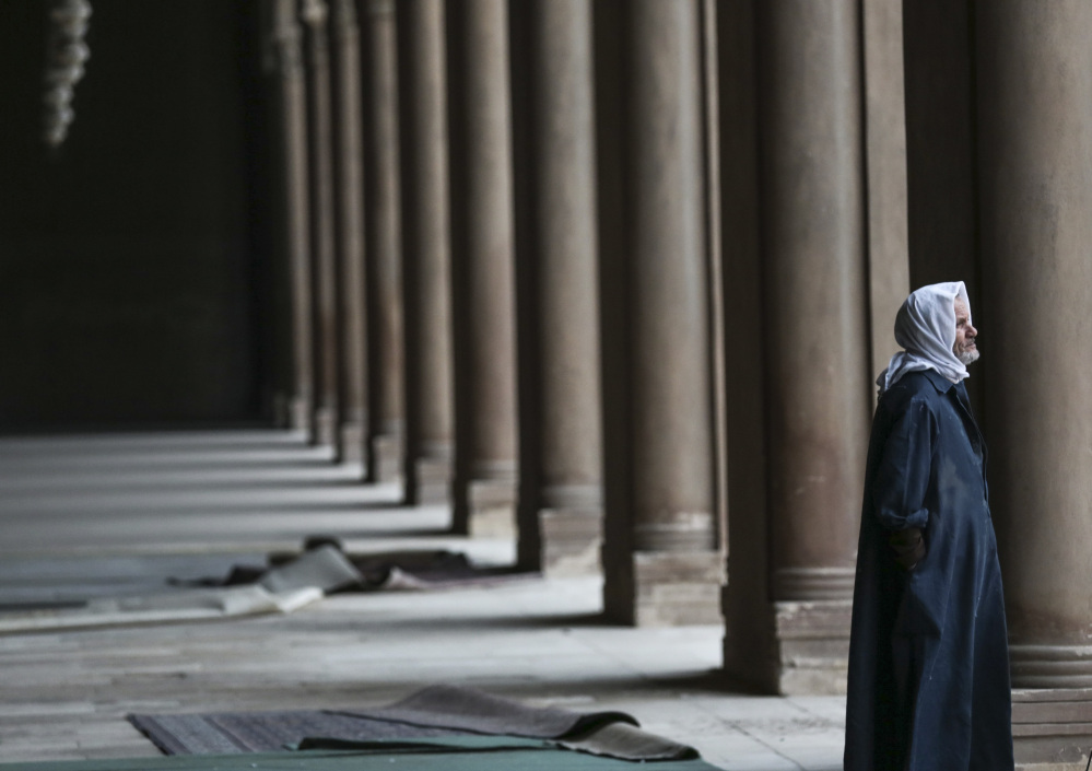 An Egyptian Muslim pauses inside Ibn-Tulun Mosque in Cairo. After the attack in Paris, there is increasing talk within Islam about whether to reject a radical minority that some fear is dragging them into conflict and ruining the faith.