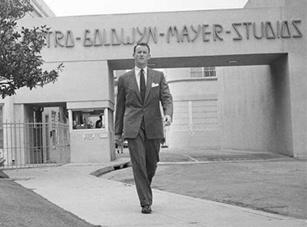 In this April 22, 1959, photo, Samuel Goldwyn, Jr., poses outside the main gate at Metro-Goldwyn-Mayer studios in the Hollywood section of Los Angeles. Goldwyn Jr., a champion of the independent film movement and son to one of the founding fathers of Hollywood cinema, died Friday from congestive heart failure, his son told the Los Angeles Times. He was 88.
