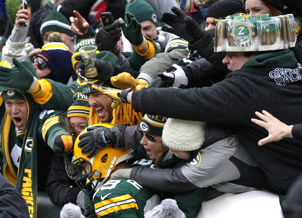Green Bay Packers tight end Richard Rodgers (89) celebrates a touchdown with fans in the second half against the Dallas Cowboys Sunday in Green Bay, Wis.