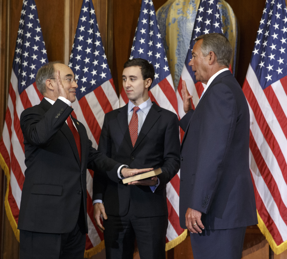 U.S. Rep. Bruce Poliquin, R-Maine, left, with his son, Sam, center, stands with House Speaker John Boehner for a ceremonial swearing-in and photo-op last week.