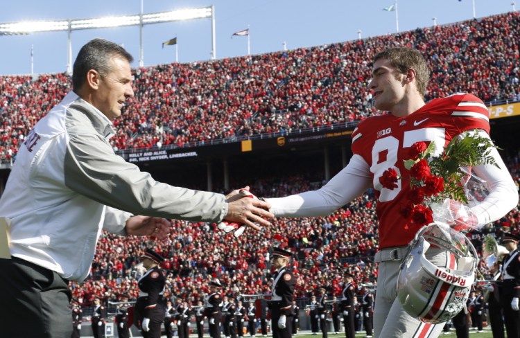 Cheverus graduate Peter Gwilym, a walk-on at Ohio State, shakes hands with Coach Urban Meyer on Senior Day, Nov. 29.