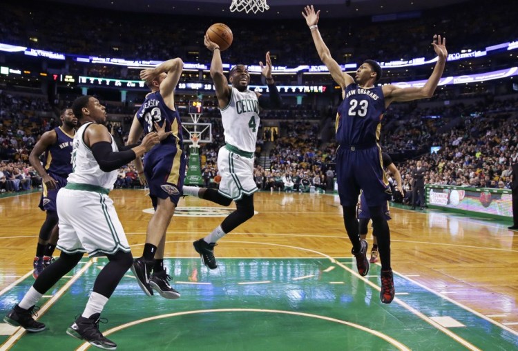Boston Celtics guard Marcus Thornton drives to the basket between New Orleans Pelicans forwards Anthony Davis (23) and Ryan Anderson (33) during the first quarter of Monday night’s game in Boston.