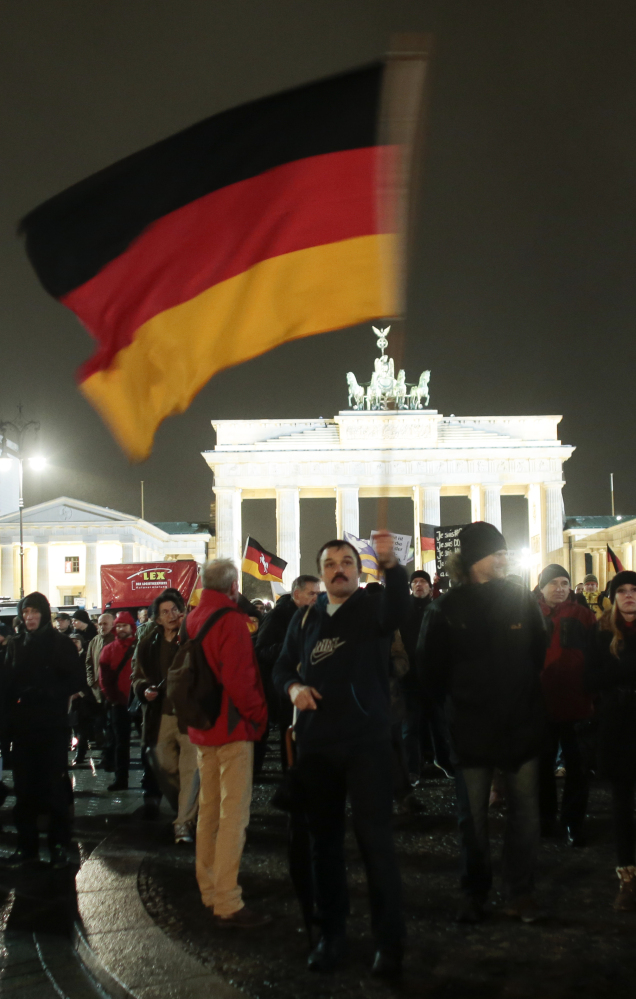 Participants in a rally called “Berlin Patriots against the Islamization of the West” march in front of the Brandenburg Gate near the French embassy in Berlin on Monday.