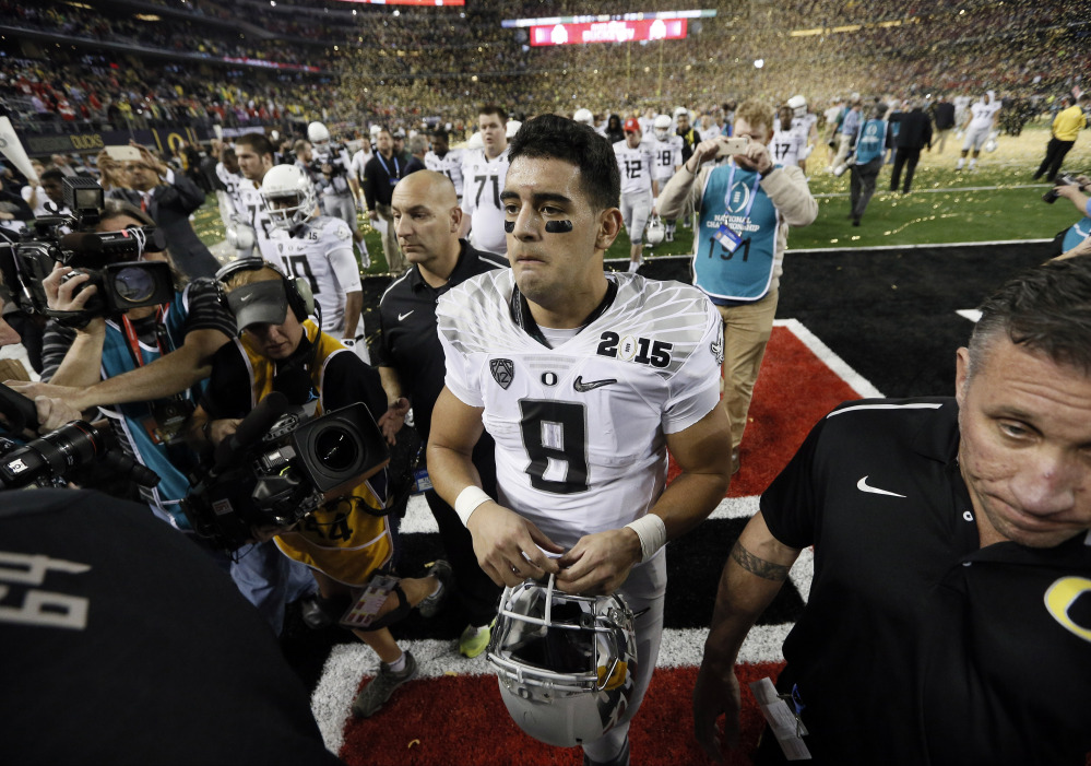 Oregon quarterback Marcus Mariota walks off the field after Monday night’s championship game against Ohio State. It likely was Mariota’s last college game, as he likely will enter the NFL draft.