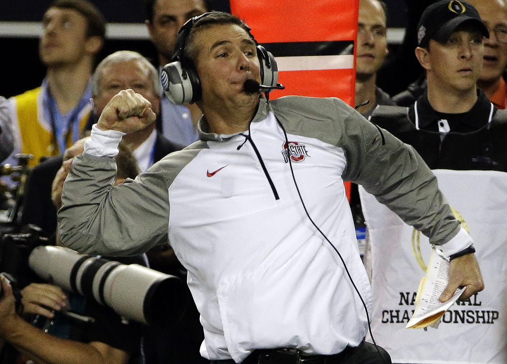 Ohio State coach Urban Meyer celebrates on the sideline during the second half of Monday night’s championship game against Oregon in Arlington, Texas. Ohio State won 42-20.