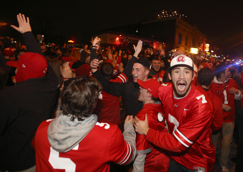 Ohio State fans block High Street in Columbus, Ohio as they celebrate the Buckeye’s 42-20 win over Oregon following the National Championship football game between Ohio State and Oregon, in Columbus, Ohio, Monday.