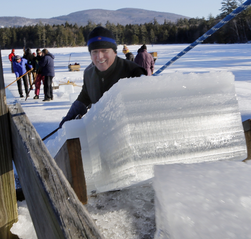 John Jurczynski loads blocks of ice, which will be stored and used in the summer at the Rockywold-Deephaven Camps instead of refrigeration units.