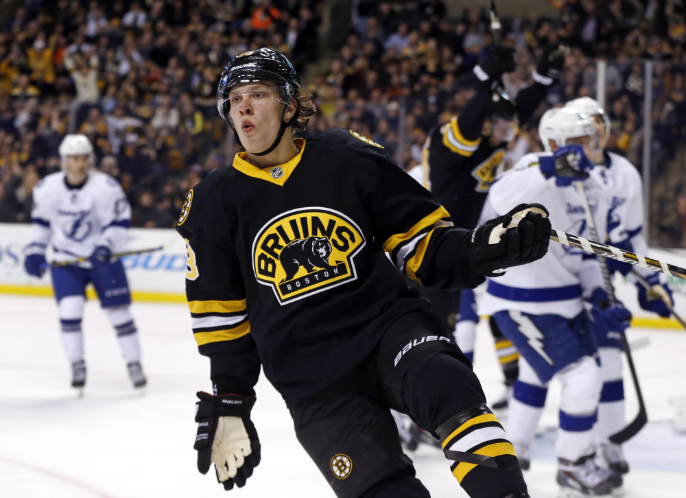 Boston Bruins left wing David Pastrnak celebrates a goal against the Tampa Bay Lightning during the second period of Tuesday night’s game in Boston. Pastrnak scored twice in the game.