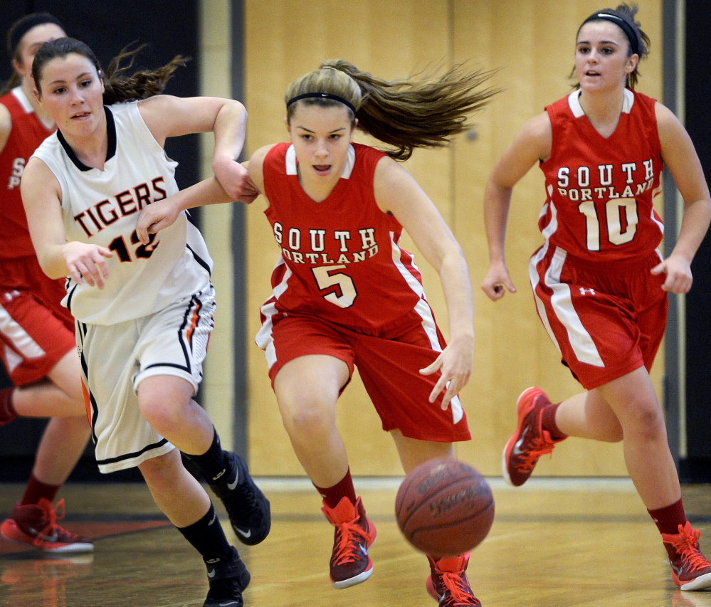 Grace Soucy of South Portland attempts to pull away from Abby Hale of Biddeford while dribbling down the court Tuesday night during South Portland’s 58-35 victory in an SMAA game on the road.