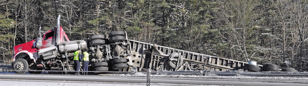 State Police troopers work the scene of a tractor trailer accident on Tuesday at Mile 111 in the northbound lane of Interstate 95 in Augusta. Traffic was backed up as it narrowed to one lane to go around the scene.