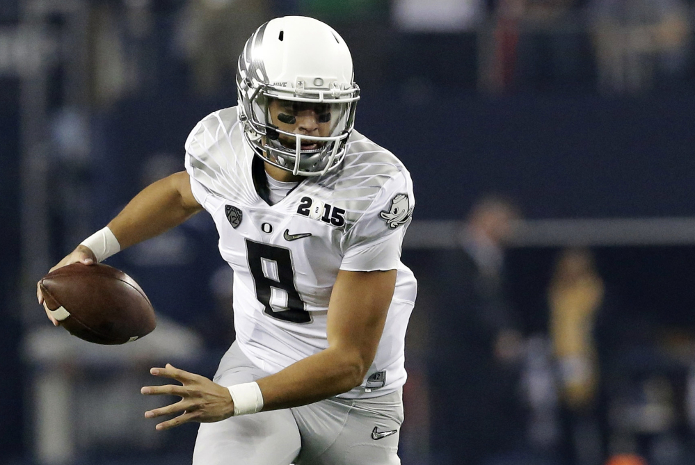 The Associated PRess
In this Monday photo, Oregon’s Marcus Mariota (8) runs against Ohio State during the first half of the NCAA college football playoff championship game in Arlington, Texas.