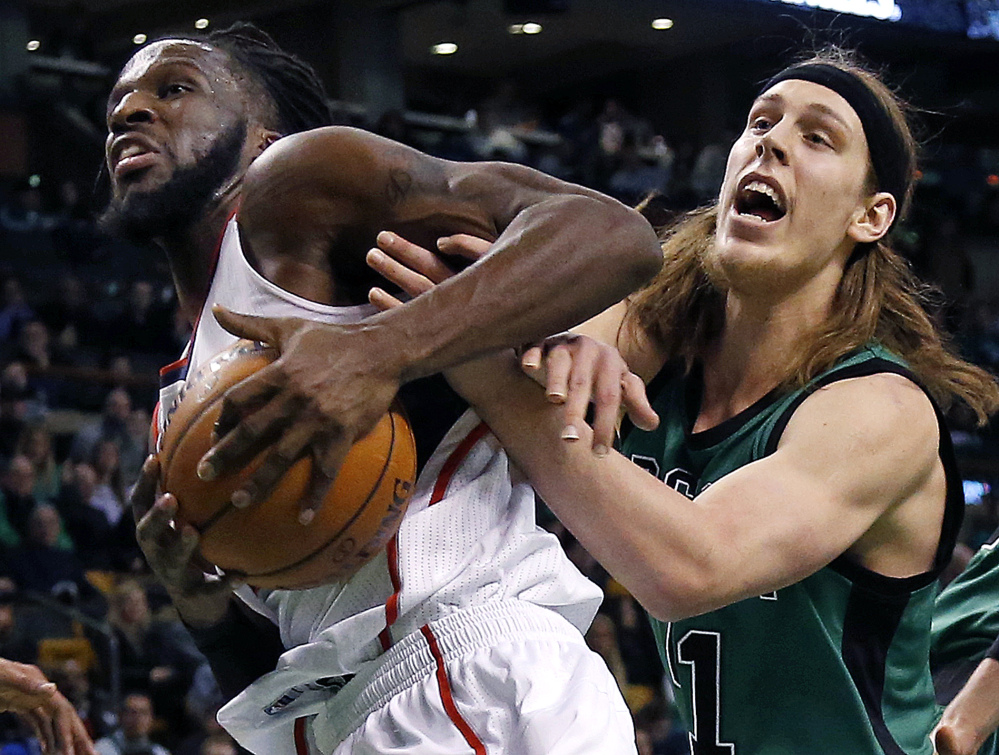 Atlanta Hawks forward DeMarre Carroll grabs a rebound away from Celtics center Kelly Olynyk during the first half of Wednesday night’s game in Boston. Carroll scored 22 points in the game.