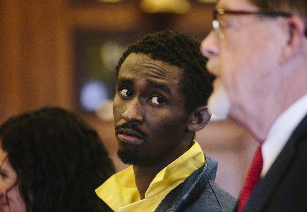 Abdirahman Huessin Haji-Hassan looks at his defense attorney Clifford Strike while he speaks to Justice Nancy Mills at his first appearance Thursday in Portland to face a murder charge in the killing of Richard Lobor in November.