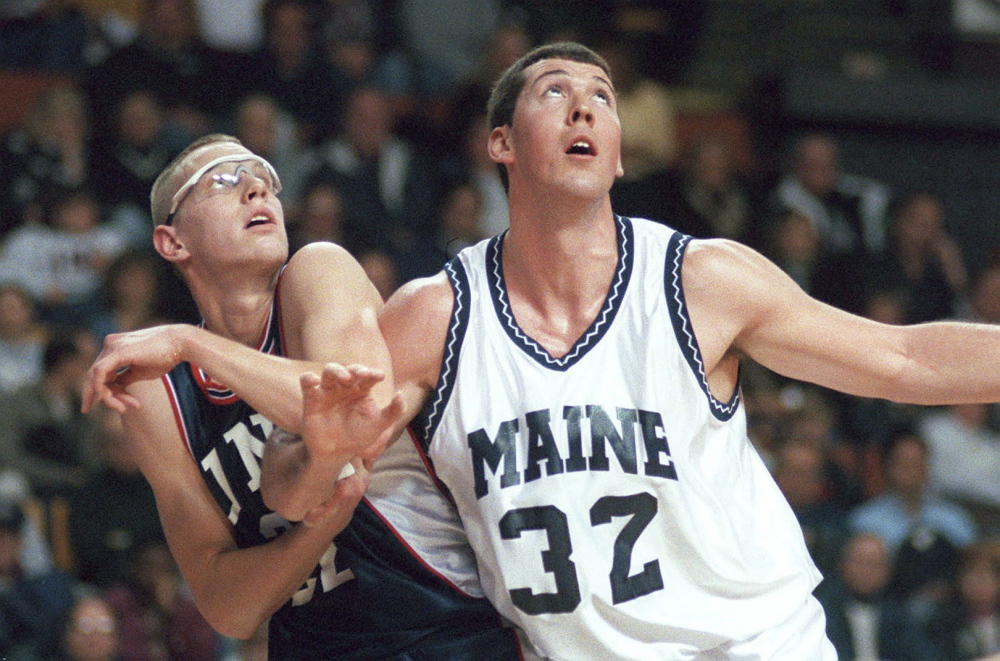 UNH’s Austin Ganley battles with UMO’s Nate Fox for rebounding position in this game photo from January 2000.