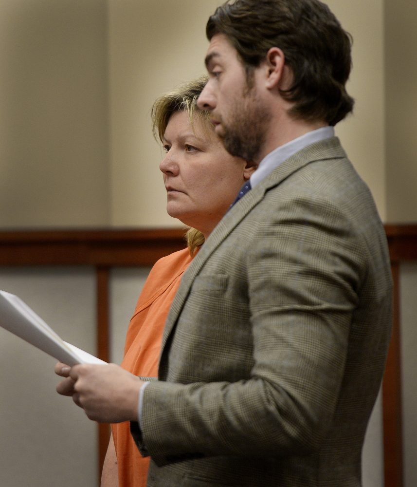 Amey Molloy appears for a hearing at the Cumberland County Courthouse in Portland with her attorney John D. Clifford V on Friday. Molloy faces theft charges in Massachusetts for allegedly defrauding the One Fund Boston.
