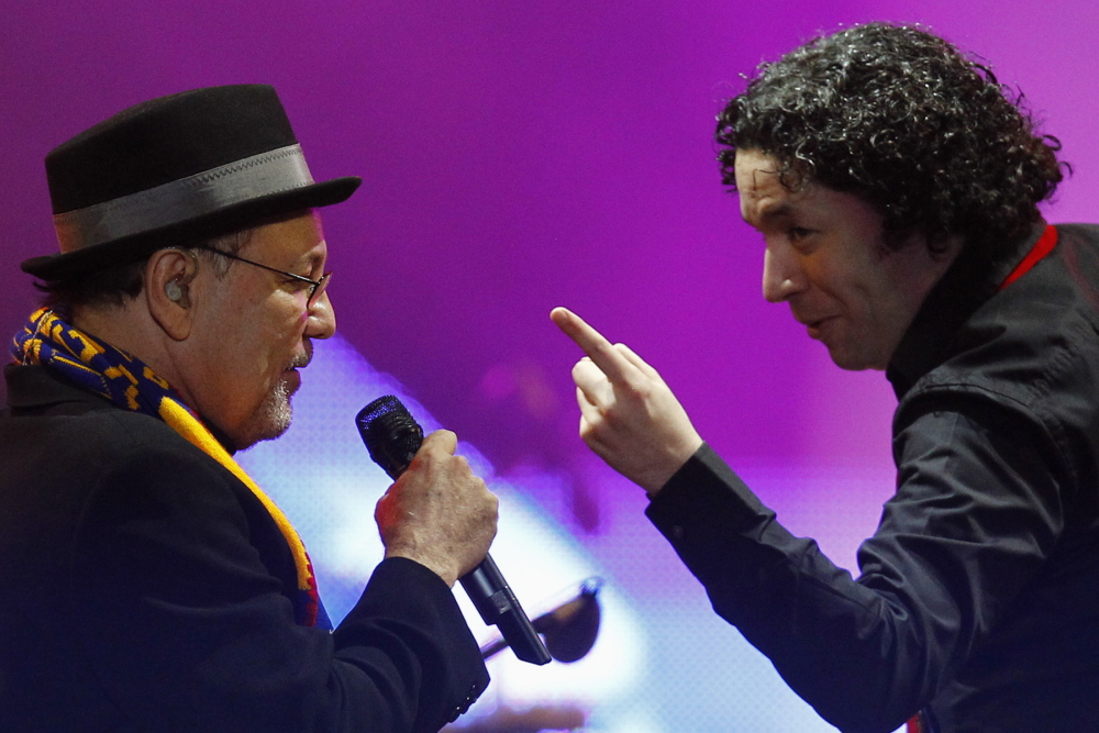Venezuelan conductor Gustavo Dudamel, right, performs with Panamanian singer Ruben Blades.