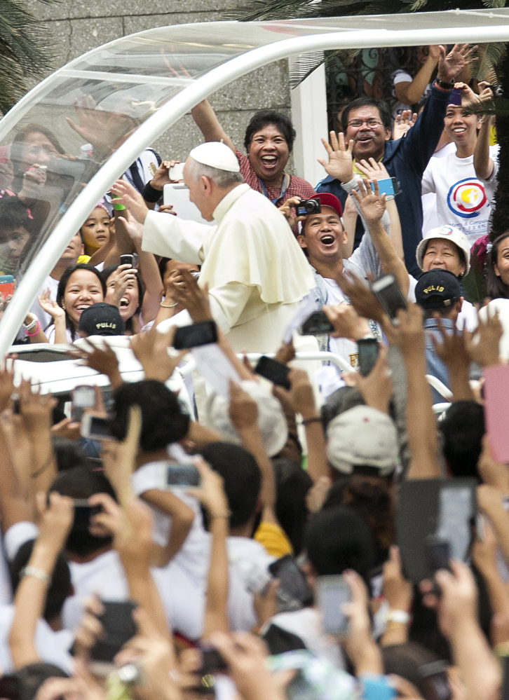 Thousands of Filipinos welcome Pope Francis upon his arrival at the Cathedral Basilica of the Immaculate Conception in Manila on Friday. 