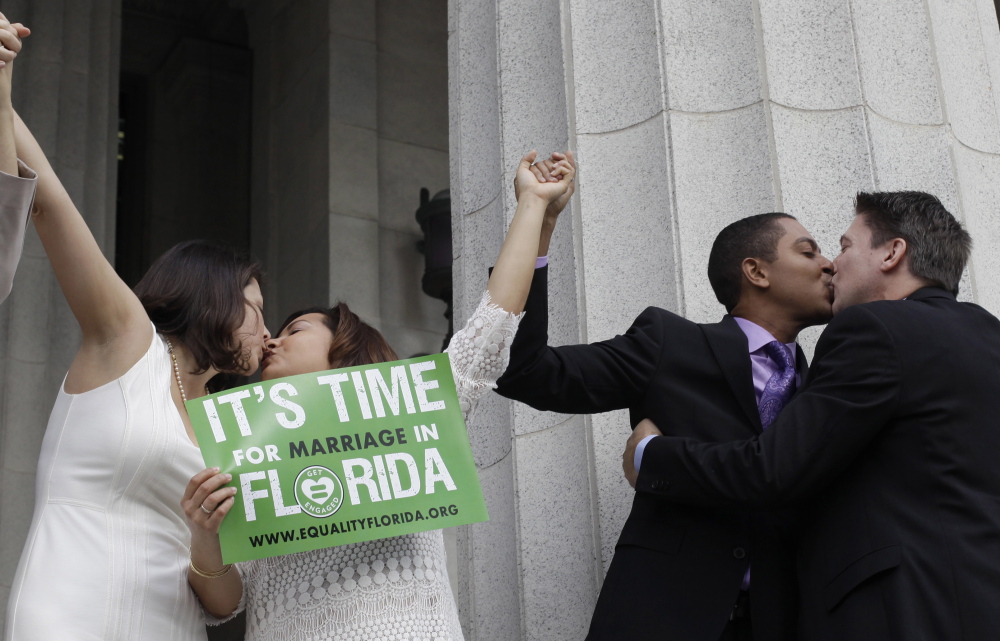 Same-sex couples marry in Miami, Florida, on Jan. 5. A judge ruled same-sex marriages could begin in Miami-Dade County on Monday, just ahead of gay couples being able to tie the knot statewide after midnight when Florida becomes the 36th U.S. state to allow people of the same sex to wed.  Picture taken January 5, 2015.   REUTERS/Javier Galeano (UNITED STATES - Tags: SOCIETY TPX IMAGES OF THE DAY) - RTR4K89X