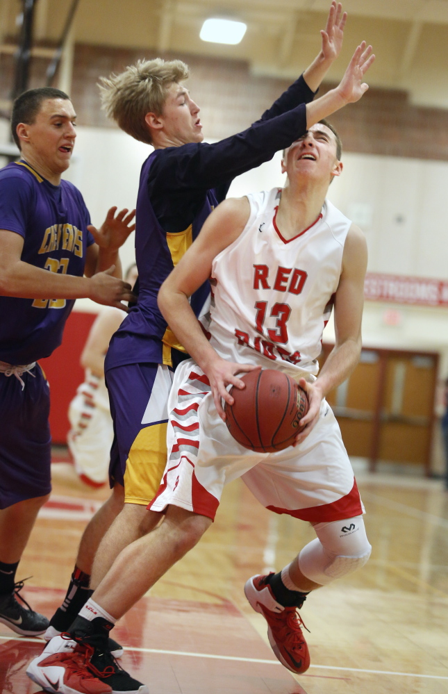 South Portland’s Jack Fiorini looks for an opening Friday against Austin Boudreau, center, and Zordan Holman of Cheverus. Fiorini scored 18 points in a 61-50 win.