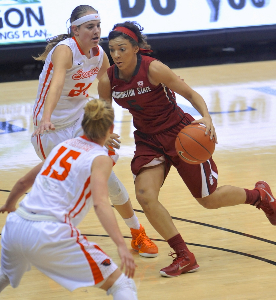 Tia Presley of Washington State drives against Oregon State’s Sydney Wiese, top, and Jamie Weisner during the first half of their Pac-12 game Friday in Corvallis, Ore. Ninth-ranked Oregon State won, 73-70.