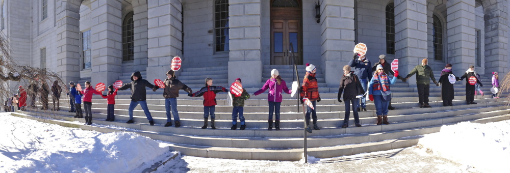 Anti-abortion activists ring the State House on a frigid Saturday in Augusta.