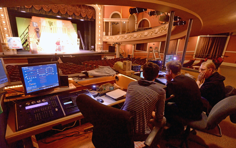 Sound and lighting technicians Logan Bard, from left, River Massey and Isaac Woods work on the lighting and sound equipment Saturday at the Waterville Opera House. The 800-seat hall is also a listening room, its marketing and development director says.