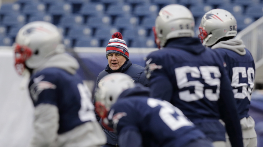 New England Patriots head Coach Bill Belichick, rear, calls to his players during his team’s football practice at Gillette Stadium in Foxborough, Mass., last week. The Patriots face the Indianapolis Colts in the AFC Championship game today for a chance to play in the Super Bowl XLIX.