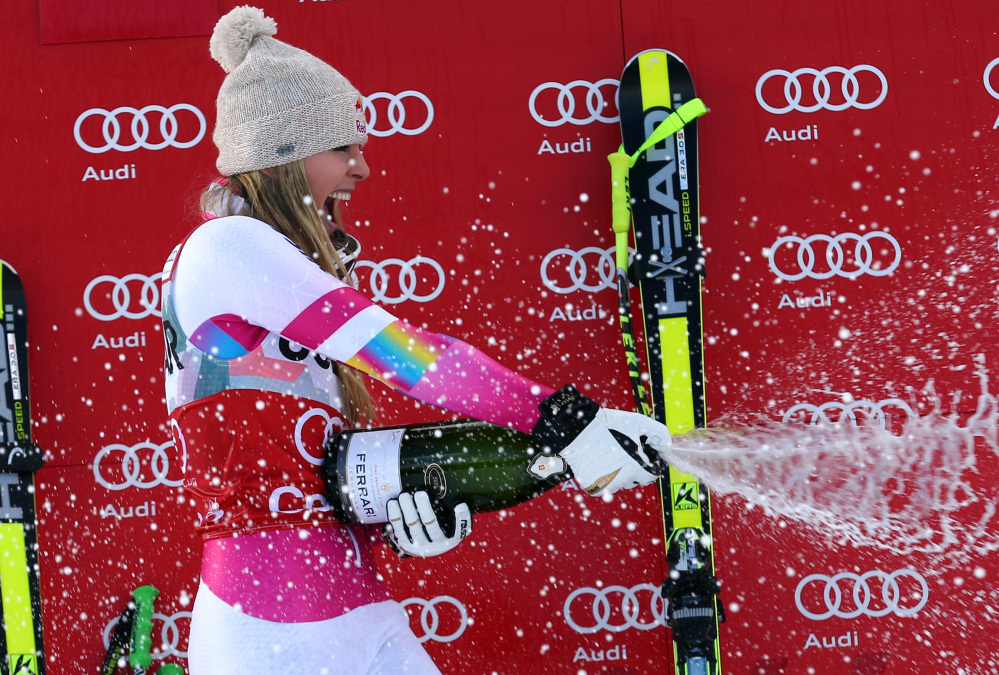 Lindsey Vonn sprays sparkling wine as she celebrates on the podium after winning the women’s World Cup downhill in Cortina d’Ampezzo, Italy, on Sunday.