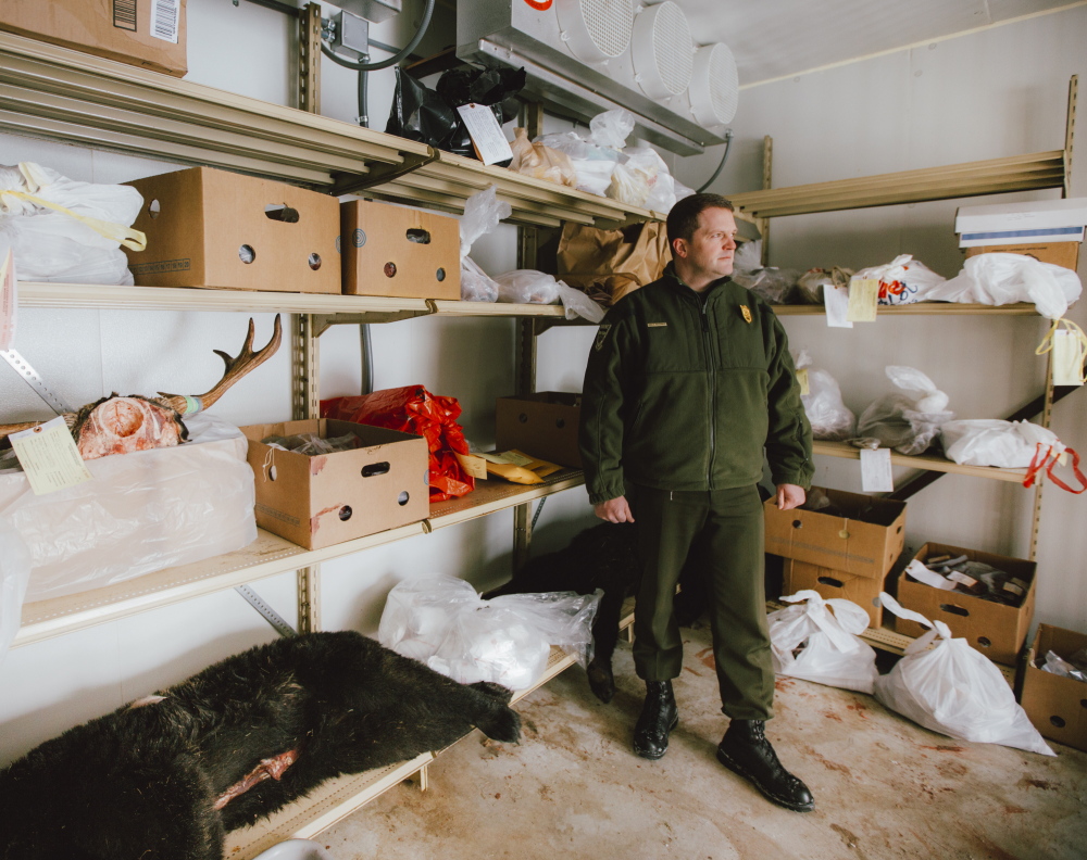 Cpl. John MacDonald of the Maine Warden Service stands in the freezer where evidence from poaching cases is stored. Much of the meat goes the Hunters for the Hungry program. Whitney Hayward/Staff Photographer