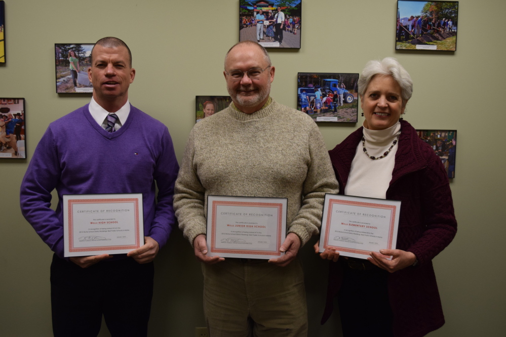 From left, Wells High School Principal Jim Daly, Wells Junior High School Principal Chris Chessie and Wells Elementary School Principal Marianne Horne received certificates of recognition from the Wells-Ogunquit Community School District School Committee for their guiding roles in helping their schools receive a high ranking among public schools in Maine in the 2015 Niche Rankings. Photo courtesy Reg Bennett