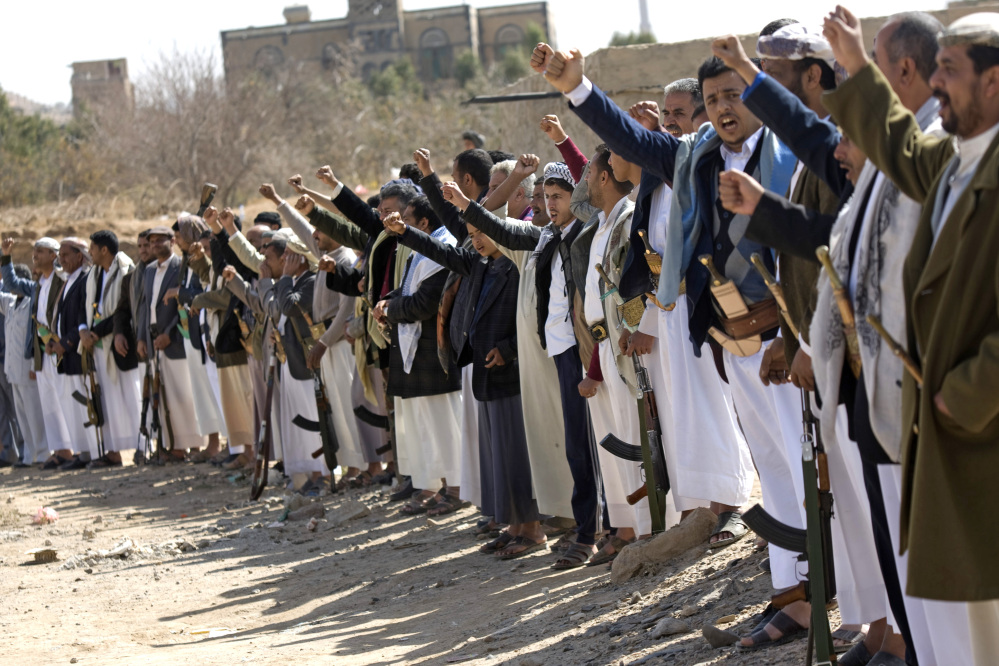 Houthi Shiite Yemeni chant slogans during clashes near the presidential palace in Sanaa, Yemen, on Monday. Rebel Shiite Houthis battled soldiers near Yemen’s presidential palace and elsewhere across the capital Monday, despite a claim of a cease-fire being reached to halt the violence, witnesses and officials said.