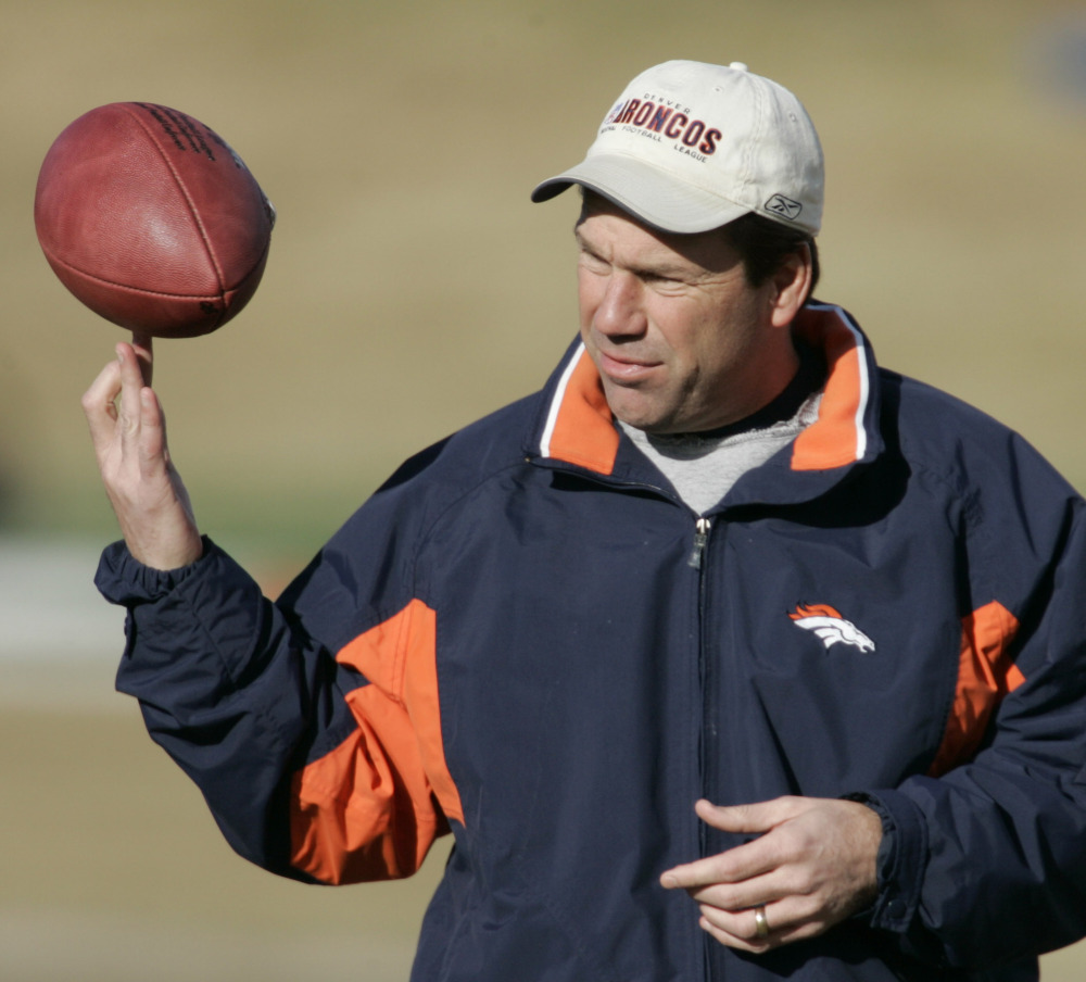 In this Jan. 4, 2006, file photo, then-Denver Broncos offensive coordinator Gary Kubiak spins a football on his finger tips as his players warmup at practice in Denver.