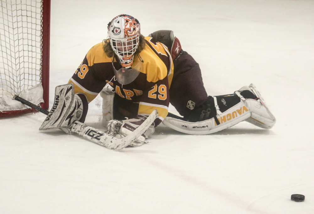 Cape Elizabeth goalie Ross LeBlond watches the puck after knocking away a shot. LeBlond earned a shut out for the Capers. LeBlond made 13 saves to record the shutout.