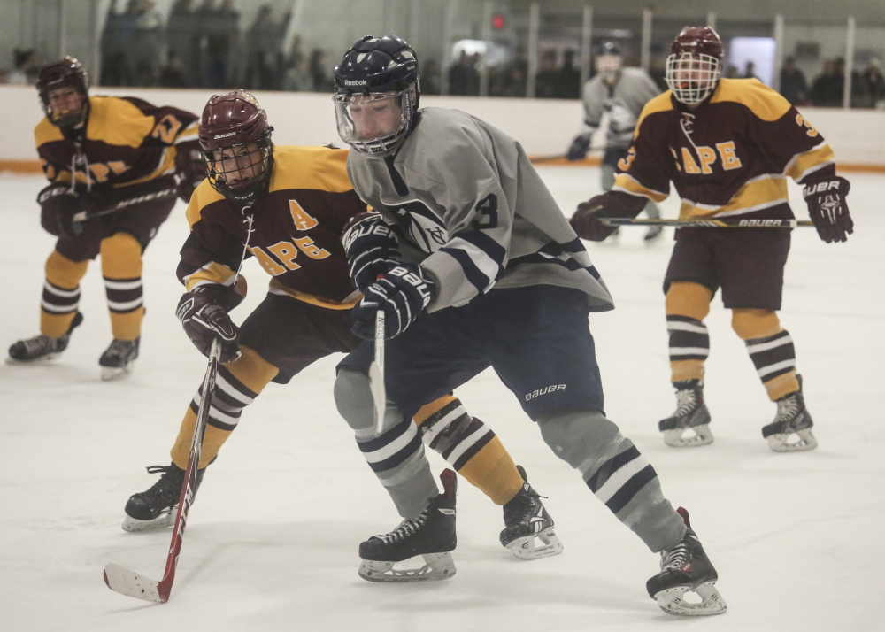 Cape Elizabeth’s Eli Babcock, left, looks to steal the puck from Yarmouth’s Bennett Travers as Travers tries to make his way to the goal during the Capers’ 2-0 win Monday at Travis Roy Arena in Yarmouth.