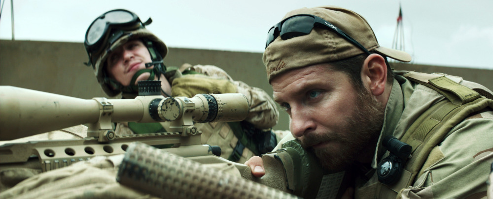 Bradley Cooper, right, appears in a scene from “American Sniper.” The movie has drawn criticism from some as military propaganda and then fierce defense from others who say veterans are underappreciated.
