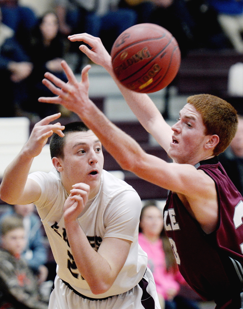 Kyle Kilfoil of Windham finds enough room to slip a pass past Nolan Smeeton of Noble. Windham improved its record to 9-4. Smeeton scored 30 points for Noble, which dropped to 2-11.