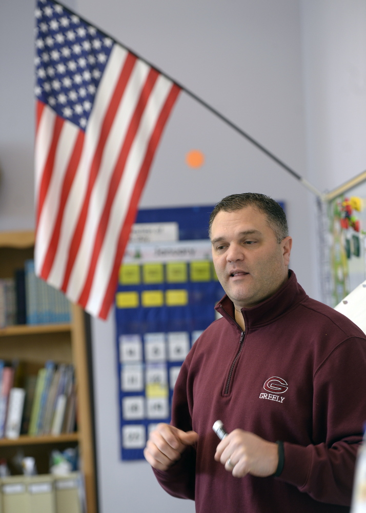 Mat Brown, a teacher at East End Community School, talks to his third-graders Wednesday about cheating in the wake of this week’s headlines. “Whether they like it or admit it, they are role models,” Brown said about pro football players.