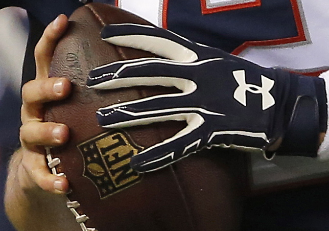 Feels good, looks good but was it legally good? And if not, who’s to blame? That’s Tom Brady holding a football – maybe one of those balls – during warm-ups Sunday before the AFC championship game against Indianapolis.