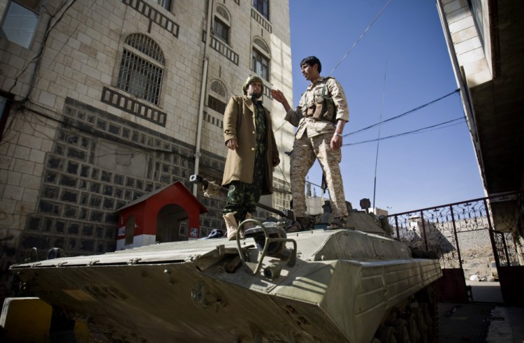 Houthi Shiite Yemeni wearing army uniforms stand atop an armored vehicle, which was seized from the army during recent clashes, outside the house of Yemen’s President Abed Rabbo Mansour Hadi in Sanaa, Yemen, on Thursday.