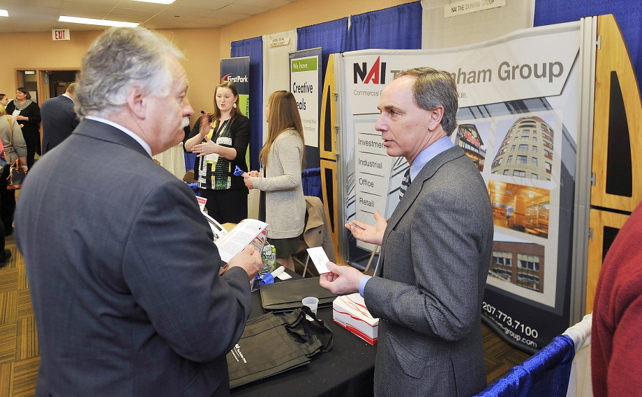 Charles Craig, with the  NAI Dunham Group, right, talks business with Jack Carr, senior vice president of Criterium Engineering, at the annual MEREDA forecasting conference Thursday at the Holiday Inn by the Bay in Portland. Gordon Chibroski/Staff Photographer