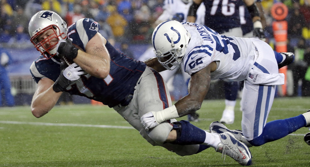 Patriots tackle Nate Solder scores on a 16-yard touchdown pass from quarterback Tom Brady during the AFC championship game last Sunday at Foxborough, Mass. The pass to the lineman was one of a number of trick plays New England has used in its playoff run.