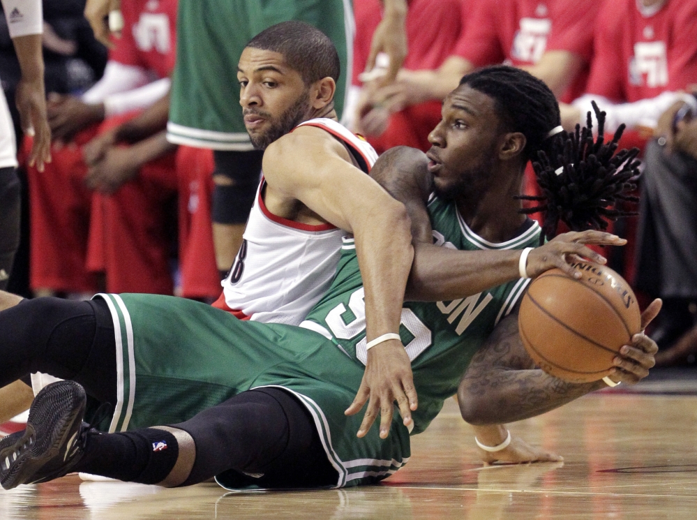 Boston Celtics forward Jae Crowder battles for the ball with Portland Trail Blazers forward Nicolas Batum during the first half of Thursday night’s game in Portland, Ore. The Celtics pulled out a 90-89 win in the last second.