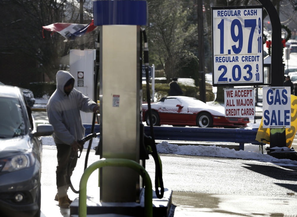 A motorist pumps gas at a station where the cash price for regular unleaded was under $2 a gallon on Jan. 9 in Leonia, N.J. For the first time since 2009, most Americans are paying less than $2 a gallon.