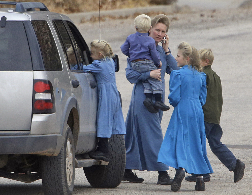 Residents walk along a street in Hildale, Utah. Some townspeople are loyal to jailed polygamist leader Warren Jeffs; others embrace government efforts to modernize the town.