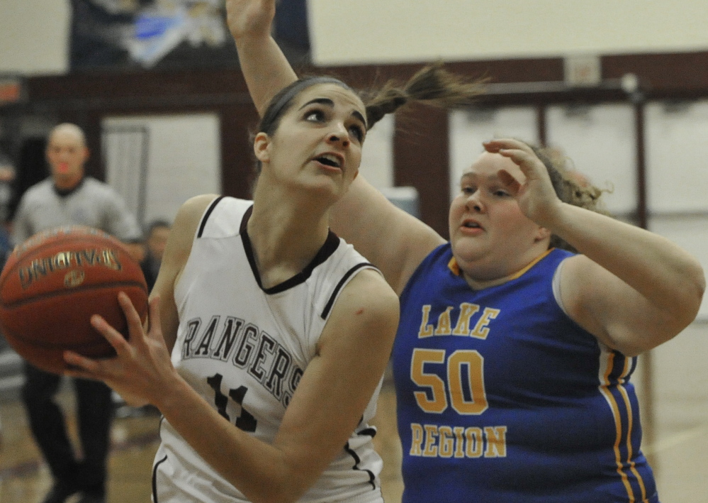 Ashley Storey, who finished with 19 points and 10 rebounds for Greely, looks for room while guarded by Megan VanLoan of Lake Region.