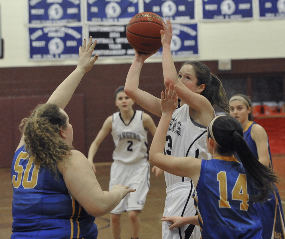 Sarah Felkel, who came through with pivotal shots and rebounds for Greely, looks to shoot while guarded by Megan VanLoan, left, and Chandler True of Lake Region. Greely has a four-game winning streak while improving its record to 11-2. Lake Region is 7-6.