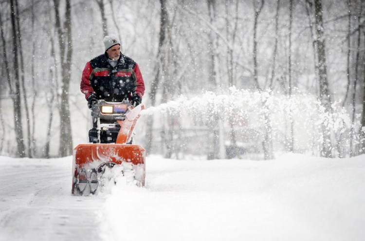Doug Vadnais of Saco snow blows his High Street driveway during Saturday’s snowfall  January 24, 2015. Patrick Ouellette/Staff Photographer