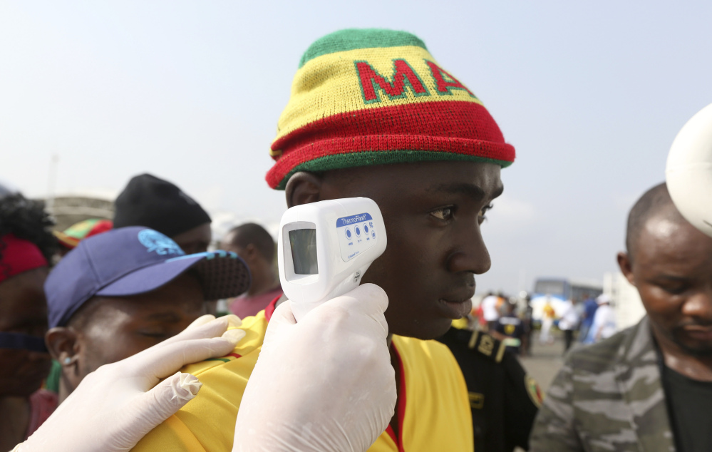 Soccer fans are checked for fever before a match last week in Malabo, Equatorial Guinea. There is still no vaccine or licensed treatment for Ebola, which has killed 8,675 people.